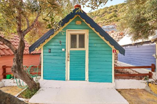 a blue house with a blue roof at Can Mocamp in Kas