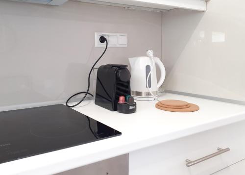 a kitchen counter with a coffee maker and a toaster at Aria, Maisonette in Glyfada Beach in Glyfada