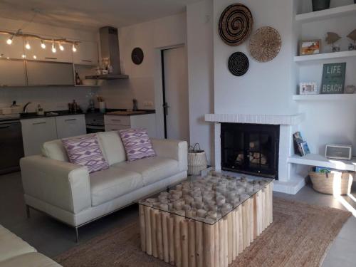 a living room with a couch and a fireplace at Beautiful Apartment in Pollença Gotmar in El Port