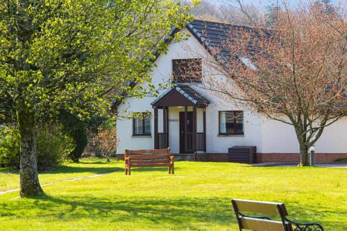 a house with a bench in front of it at Auchrannie Resort in Brodick