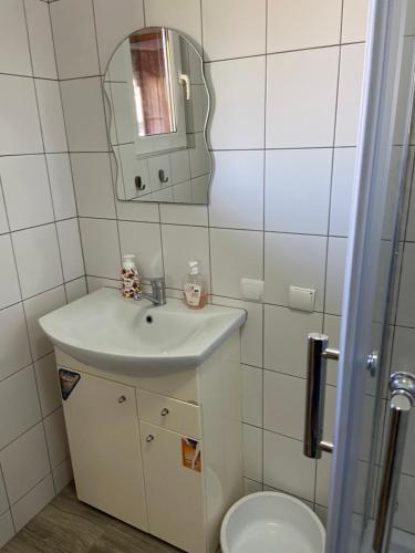 a bathroom with a sink and a toilet at Domek wakacyjny in Charzykowy