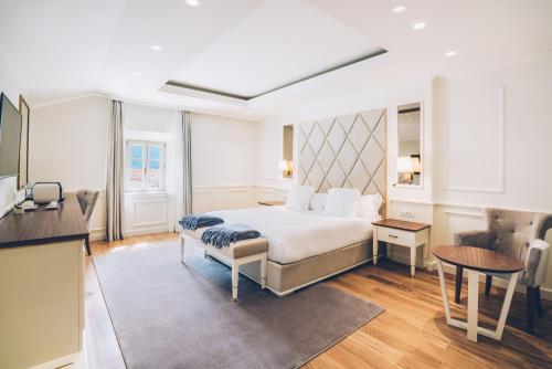 a hotel room with a bed and a table at Heritage Grand Perast By Rixos in Perast