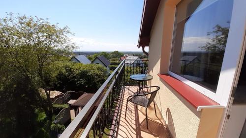 a balcony with a table and chairs on it at Waldek in Jastrzębia Góra