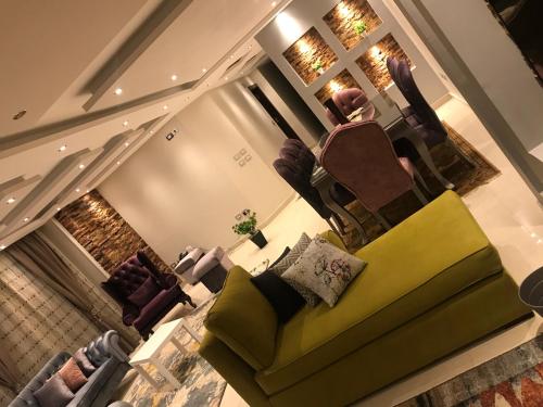 an overhead view of a living room with a yellow couch at Cozy and Modern Apartment for Rent in Mohandessin in Cairo