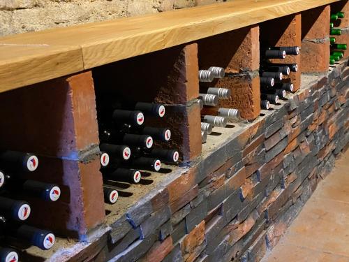a wall of wine bottles in a wine cellar at Vila dům Emma in Bořetice