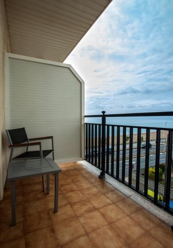 a balcony with a bench and a view of the ocean at Hotel Horitzó by Pierre & Vacances in Blanes