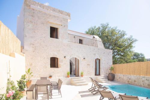 an external view of a house with a swimming pool at Villa Evelyn in Metochia Fratzeskiana