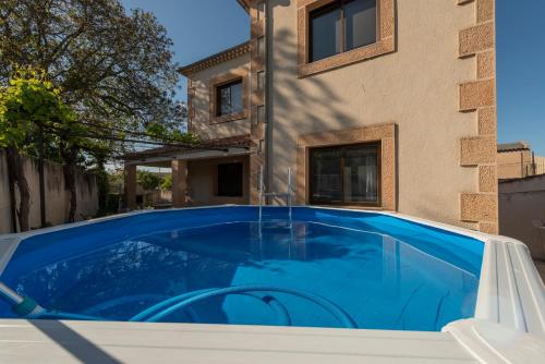 a swimming pool in front of a house at VuT El Pozo la Carrera in San Pedro de Gaíllos