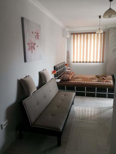 a living room with a couch and a bed at Studio Emi in Pomorie