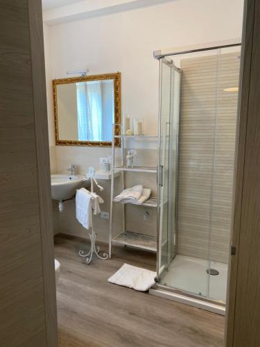 a bathroom with a glass shower and a sink at UNIQUE ROOMS in Verona
