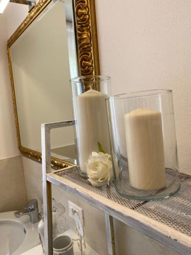 a candle on a shelf in front of a mirror at UNIQUE ROOMS in Verona