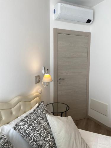 a bedroom with a bed and a door with a fan at UNIQUE ROOMS in Verona