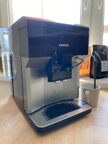 a laptop sitting on top of a coffee maker at Vila dům Emma in Bořetice