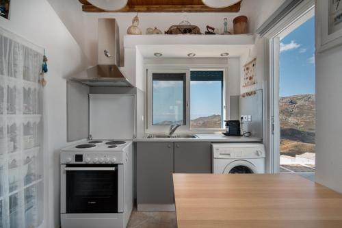 a kitchen with a stove and a dishwasher at SeaScapeHome Serifos in Serifos Chora