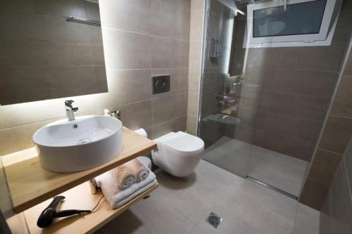 a bathroom with a sink and a toilet and a shower at Preveza Suitestay Apartments Dodonis 28 in Preveza