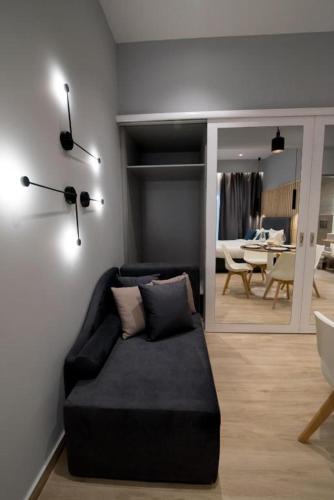 a living room with a couch and a mirror at Preveza Suitestay Apartments Dodonis 28 in Preveza