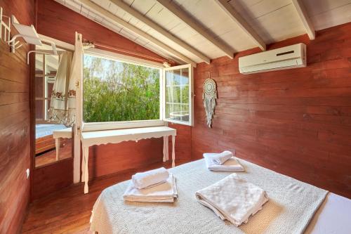 a room with a bed with a window and a sink at Can Mocamp in Kas