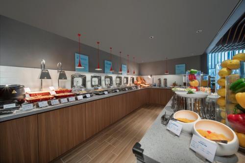 a buffet line in a restaurant with food at Holiday Inn Express Zhuhai Gongbei by IHG in Zhuhai