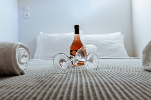 a bottle of booze sitting on top of a bed at Traditional Apartments Elafos in Elafonisi
