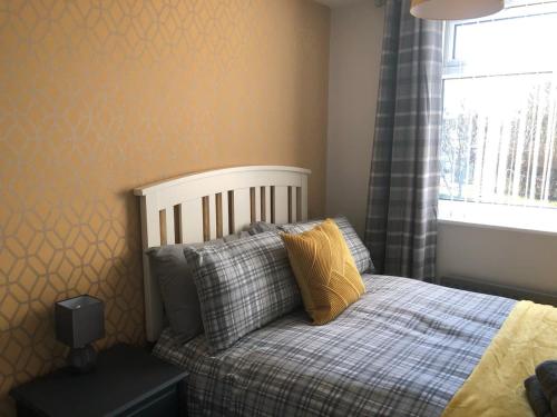 a small bedroom with a bed and a window at Rowan Place 5 Bedroom Off Street Parking Accommodation in Durham
