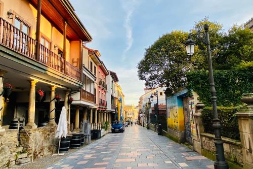 a cobblestone street with a car driving down it at Casa Vacacional Galiana in Avilés
