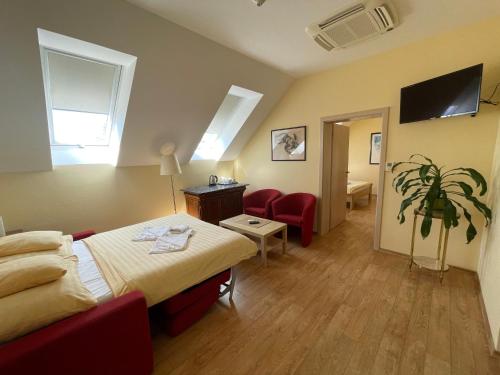 a hotel room with a bed and a chair at Penzion U Bohuša in Lednice