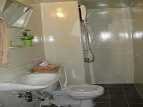 a bathroom with a toilet and a sink and a shower at IMPACT Challenger Apartment Hostel Bangkok Thailand in Pak Kret