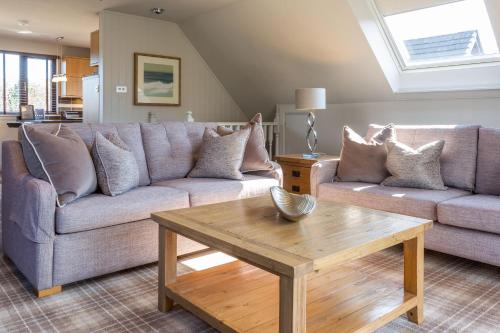 a living room with a couch and a coffee table at Auchrannie Resort in Brodick
