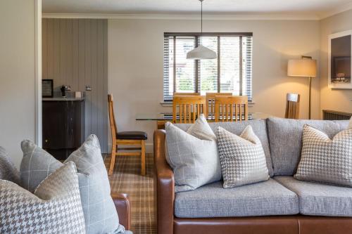 a living room with a couch and a table at Auchrannie Resort in Brodick