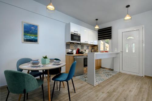 a kitchen and dining room with a table and chairs at Villa Alexandra in Boukari