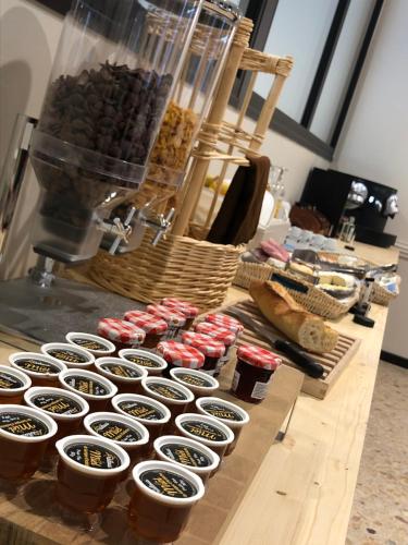 a counter with cupcakes and other food on it at Hôtel et appartements les platanes in Thueyts
