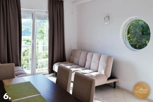 a living room with a couch and a table at Resort Stikovic in Dobra Voda