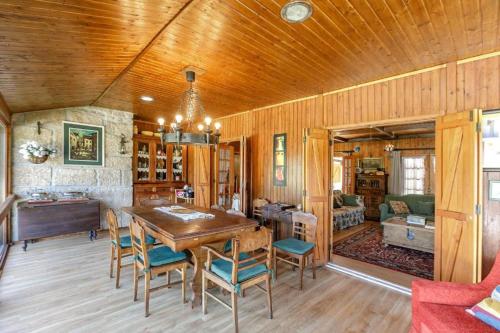 a dining room with a wooden table and chairs at LovelyStay - Toca dos Coelhos in Marco de Canaveses