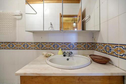 a bathroom counter with a sink and a mirror at LovelyStay - Toca dos Coelhos in Marco de Canaveses