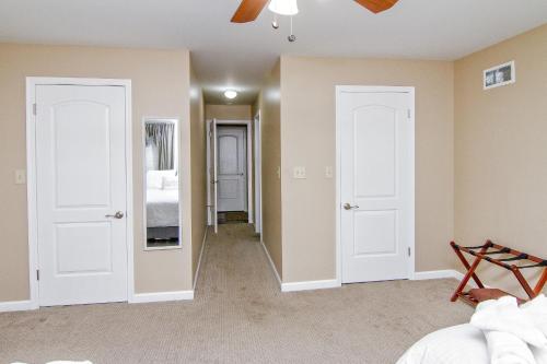 a living room with two doors and a bedroom at Cabin by the Creek with private creek access in Tannersville