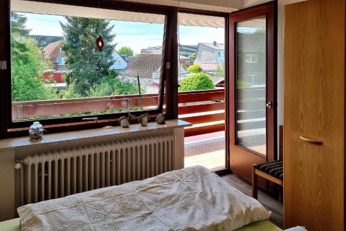 a bedroom with a bed and a large window at Ferienwohnung Alte Liebe in Husum