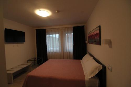 a hotel room with a bed and a window at Hotel Cajeta in Buia
