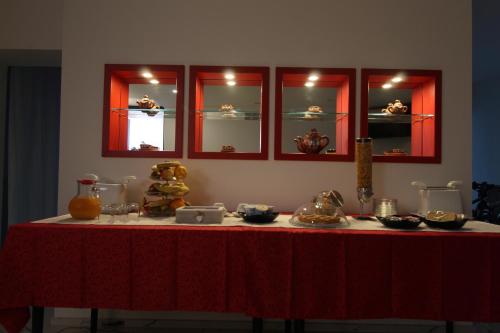 a table with a red table cloth on top of it at Hotel Cajeta in Buia