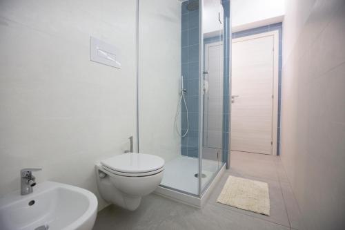 a white bathroom with a toilet and a shower at Appartamento Limone in Splendida villa Nature al mare di Scopello Zingaro in Scopello