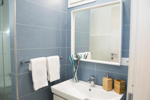 a bathroom with a white sink and a mirror at Appartamento Limone in Splendida villa Nature al mare di Scopello Zingaro in Scopello