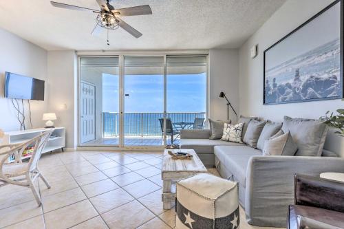 a living room with a couch and a table at Gulf Shores Condo with Ocean Views and Beach Access! in Gulf Highlands