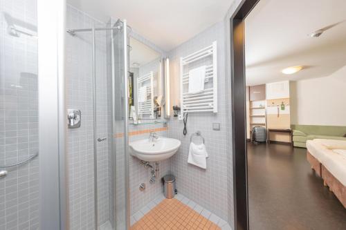 a bathroom with a sink and a shower at Radlhotel Wassertrüdingen in Wassertrüdingen