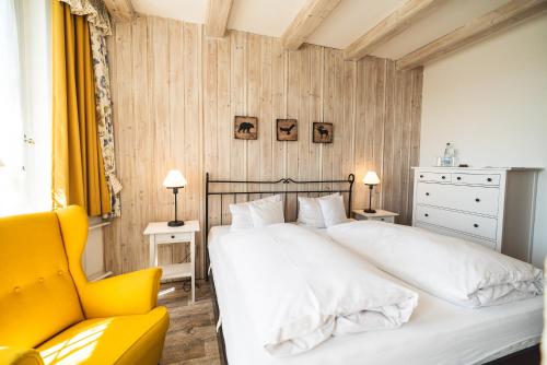 En eller flere senge i et værelse på Landhotel Villa Foresta