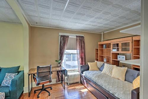 a living room with a couch and a desk at Pet-Friendly Finger Lakes Home Near Wineries! in Ovid