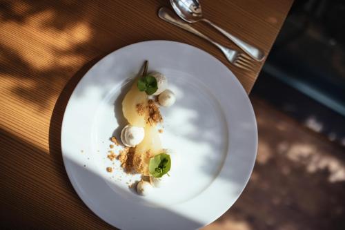 a white plate with a dessert on a table at Hotel Rablanderhof in Rablà