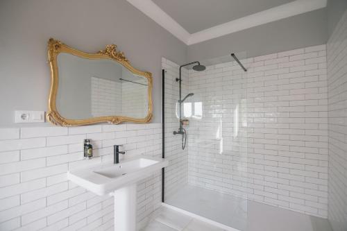 a white bathroom with a sink and a mirror at Villa Dora (Only adults) in Jávea