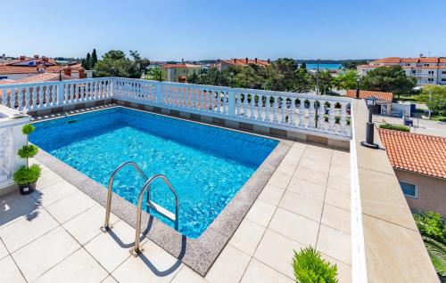a swimming pool on the roof of a building at Villa San Rocco Bed & Breakfast in Medulin