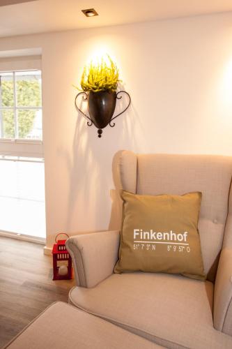 a living room with a couch and a light fixture at Landhotel Voss im TalVital in Saalhausen