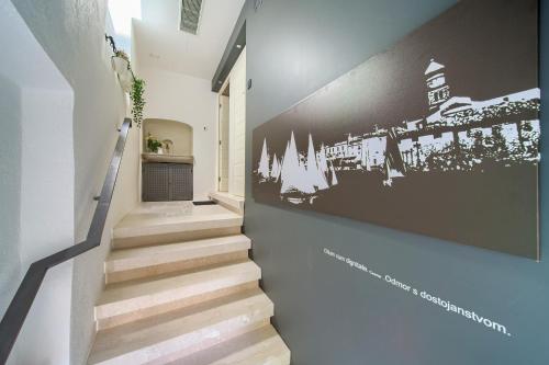 a staircase with a black and white picture on the wall at Apartments Bastinica in Krk