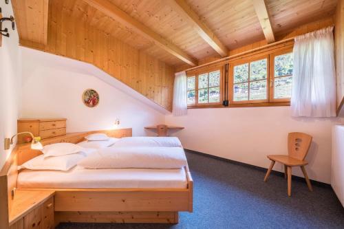 a bedroom with a bed in a wooden house at Baumgartnerhof Appartment Kornus in Lagundo